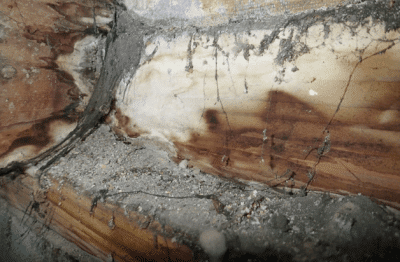 Discoloration on wood framing below vent from previous moisture intrusion
