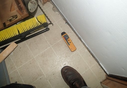 Wet flooring detected near back door entrance