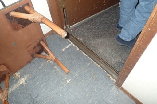 Water damage and mold growth extends out to exterior garaged door entry way.