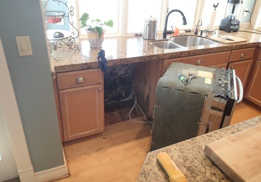 Dishwasher removed to inspect affected materials behind