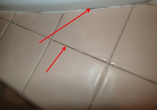 Several areas of failed grout and caulking on tub surround
