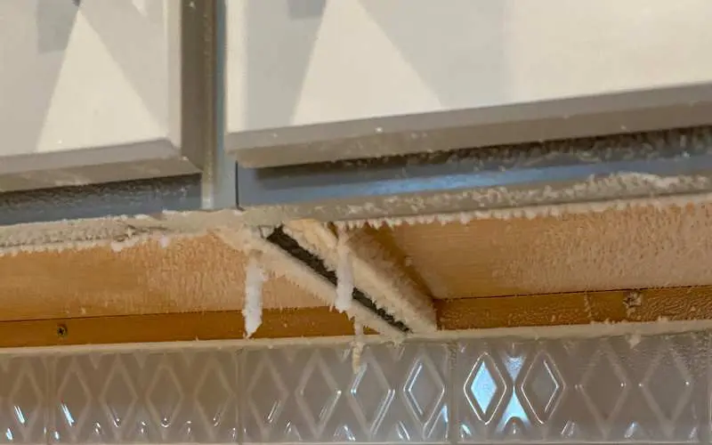 Possible white mold on kitchen cabinets.