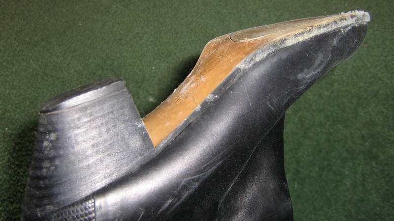 White mold growth on black leather shoe.